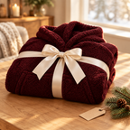 Wine red Hibernation Hoodie folded and tied with a cream ribbon as a gift