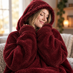 Close up of a woman nuzzling into the plush hood of the wine red Hibernation Hoodie